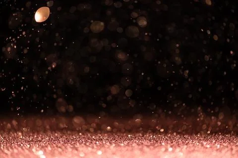 Pink sequins fall on a black background Stock Photos
