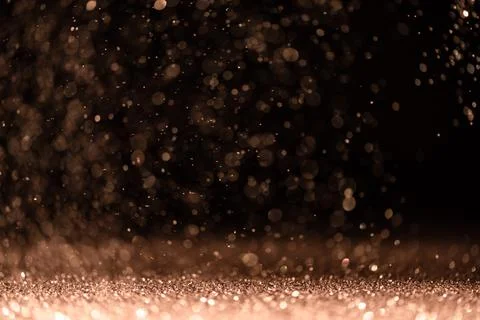 Pink sequins fall on a black background Stock Photos