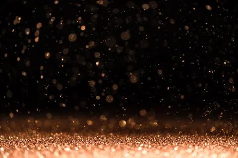 Pink sequins fall on a black background Stock Photos