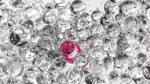 Pink serum with liquid bubbles in a 3D abstract background. Hydrating essence ge Stock Footage 294990684