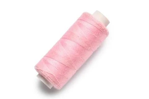 Pink sewing thread on white background Stock Photos