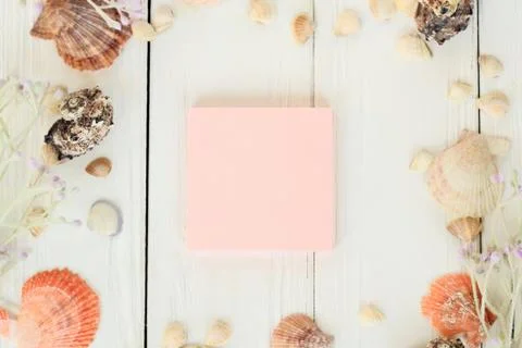 Pink sheet to record and seashells on a wooden background.Travel background Stock Photos