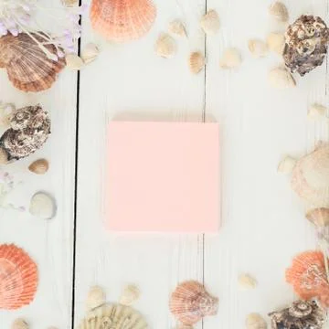Pink sheet to record and seashells on a wooden background.Travel background Stock Photos