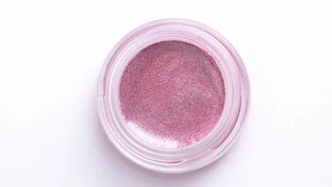 Pink shiny eyeshadow rotating on white background. Advertising cosmetics. C.. Stock Footage 248379902