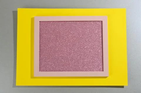 Pink shiny rectangular frame on gray-yellow background with shadow Stock Photos