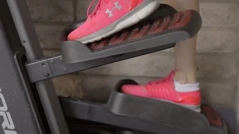 Pink shoes on step machine Stock Footage 249290426