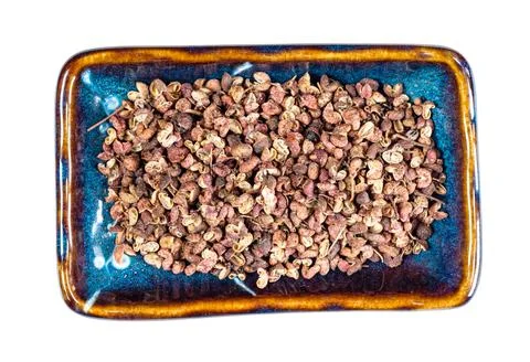 Pink sichuan pepper on rectangular plate cutout Stock Photos