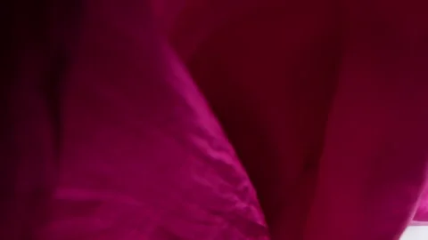 A pink silk scarf falls gently on a clean white background in slow motion. Stock Footage 337402821