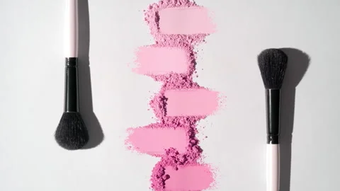 Pink smeared powder heaps on light grey background Stock Footage 343048627