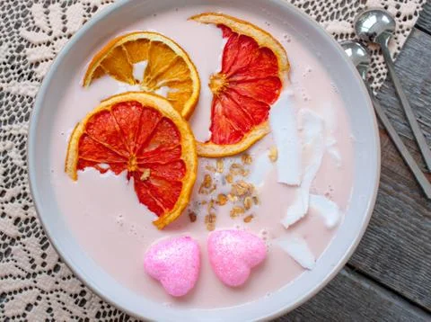 Pink smoothies with raspberry, coconut, oranges Stock Photos