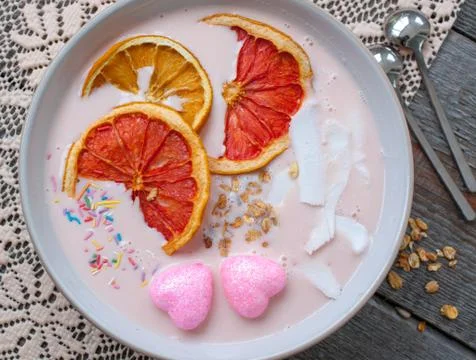 Pink smoothies with raspberry, coconut, oranges Stock-Fotos