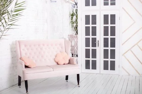 Pink sofa on a white wall background Stock Photos