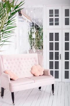 Pink sofa on a white wall background Stock Photos