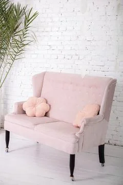 Pink sofa on a white wall background Stock Photos