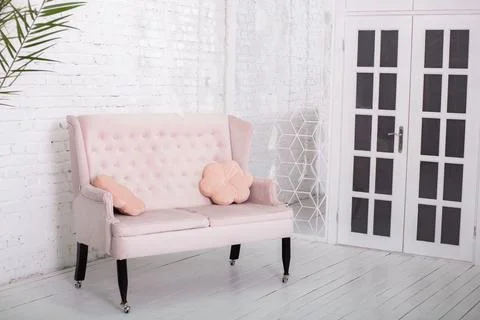 Pink sofa on a white wall background Stock Photos