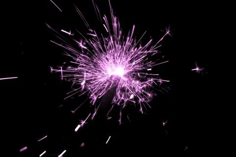 Pink sparkler countdown on fire with spread of glitter sparks. Luxury enterta Stock Photos