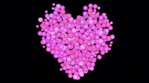 Pink spheres tumble down to form a heart - black background. Stock Footage 71764433