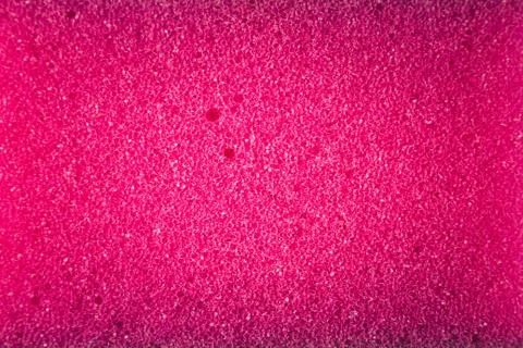Pink sponge made of microfiber material. Texture, background. In Increase Фото
