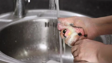 Pink sponge squeezed as foam drips Stock-Footage 229560818
