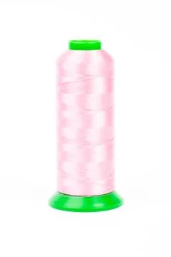 Pink spool of thread on white background Foto stock