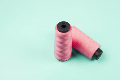 Pink spools mint background Stock-Fotos