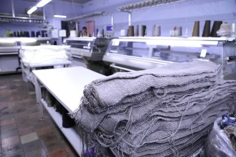 Pink spools of thread on the background of the sewing workshop. Clothing Stock Photos