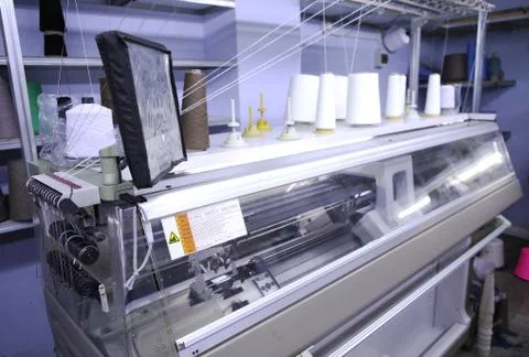 Pink spools of thread on the background of the sewing workshop. Clothing Stock Photos