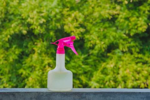 Pink spray bottle on ledge Stock Photos