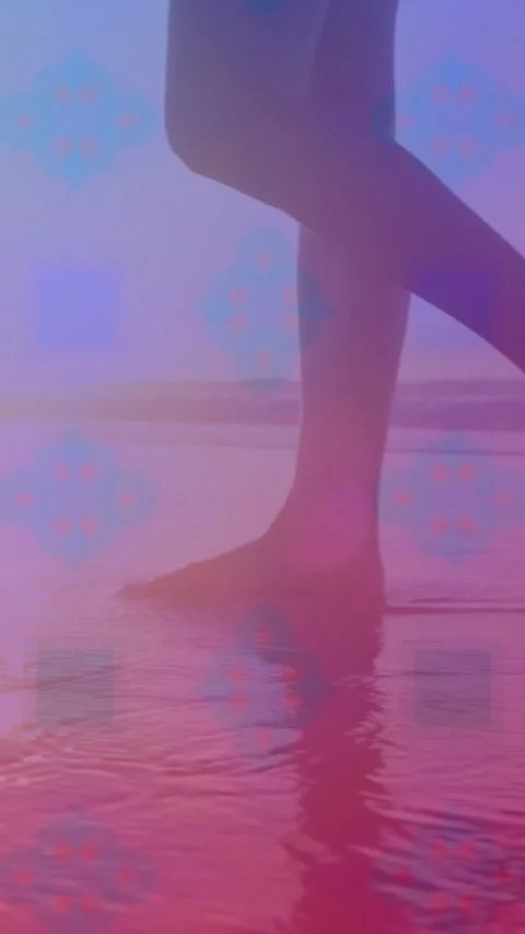Pink square design pattern against low section of a woman walking on the beach Stock Footage 343128162