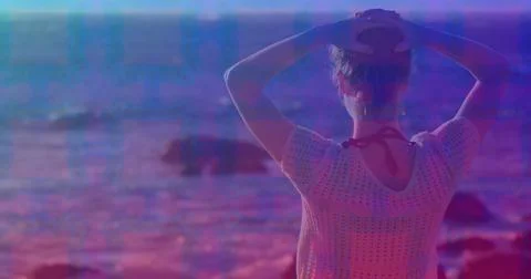 Pink square design pattern against rear view of caucasian woman standing on the Stock Photos