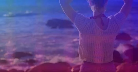 Pink square design pattern against rear view of caucasian woman standing on the Stock Photos