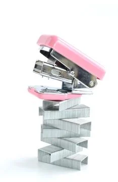 Pink stapler with staples stack Photos