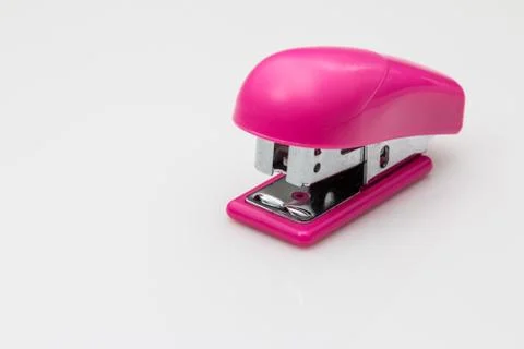 Pink stapler on white background. Stock Photos