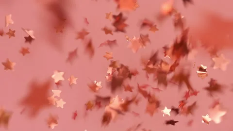 Pink stars from blown confetti cracker fall on surface Stock Footage 217797520