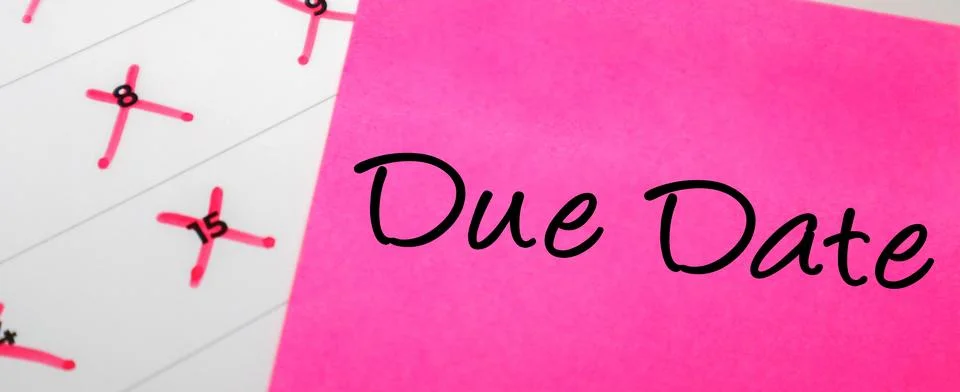 Pink sticky note with Due Date text placed over a paper calendar with speci.. Stock Photos