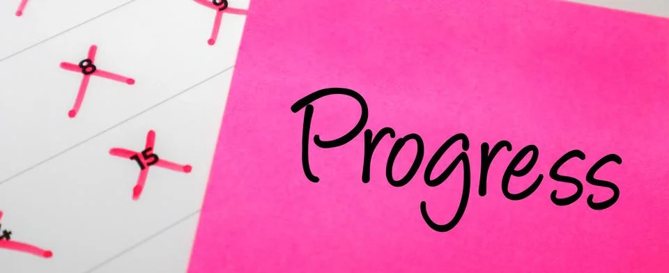 Pink sticky note with Progress text on a calendar with red marked dates. Co.. Stock Photos