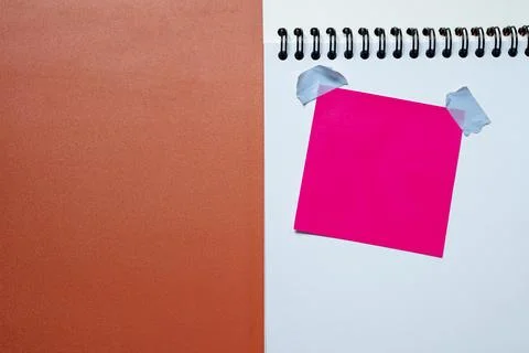 Pink sticky note on a spiral bound notebook Stock Photos