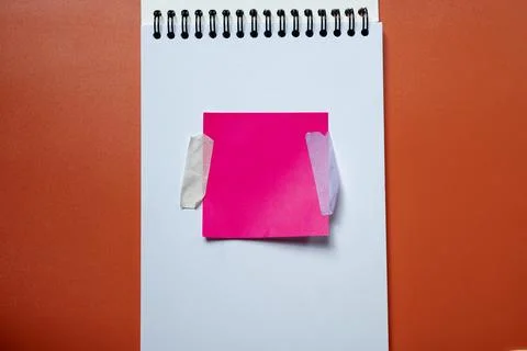 Pink sticky note on a spiral bound notebook Stock Photos