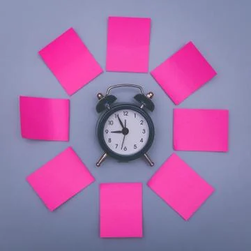 Pink sticky notes and clock, memory concept background. Stock Photos
