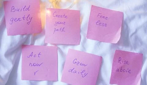 Pink sticky notes featuring handwritten psychological health and personal gro Stock Photos