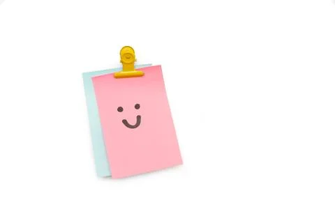 Pink sticky paper note with the draw of a face smiling Foto stock