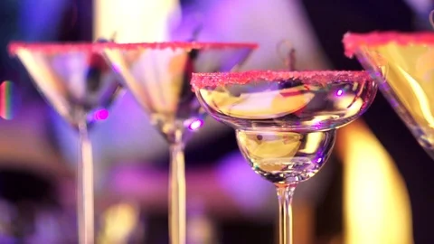 Pink sugar on empty Martini and Margarita glasses on a party night at fancy bar Stock-Footage 116719230
