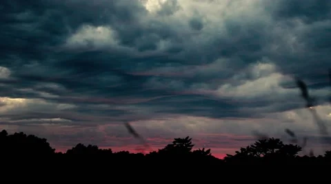 PINK SUNRISE LIGHT BREAKS THROUGH STORM TIME LAPSE Stock Footage 66687779