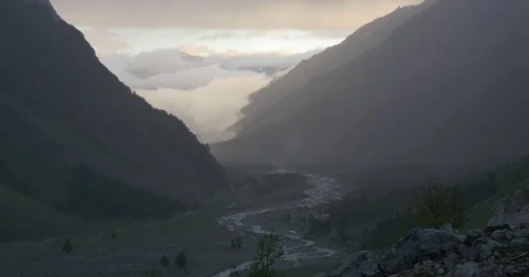 Pink sunset clouds lower thah mountains Stock Footage 77242986