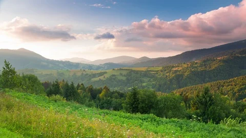 Pink Sunset Clouds over Forested Mountains. Time Lapse 4K 動画素材 106459037