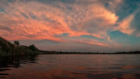 Pink Sunset Clouds Over River Stock Photos
