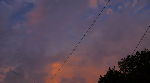 Pink sunset clouds with wire power in the city Stock Footage 68330611