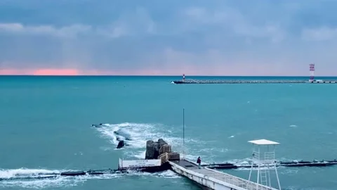 Pink sunset harbor harbor waves sea beach shore Stock Footage 219376388