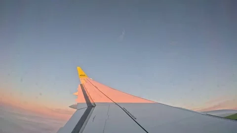 Pink sunset light reflection on airBaltic airplane wing flying above clouds Stock-Footage 342533825