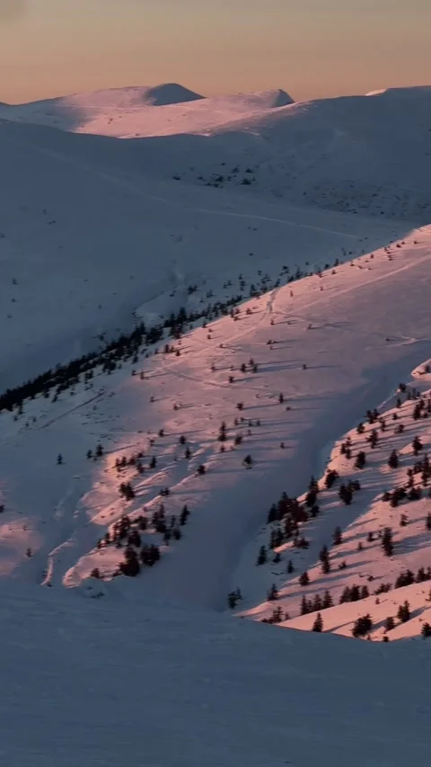 Pink sunset light on snowy mountain slopes, Drahobrat, Ukraine Stock Footage 346591158